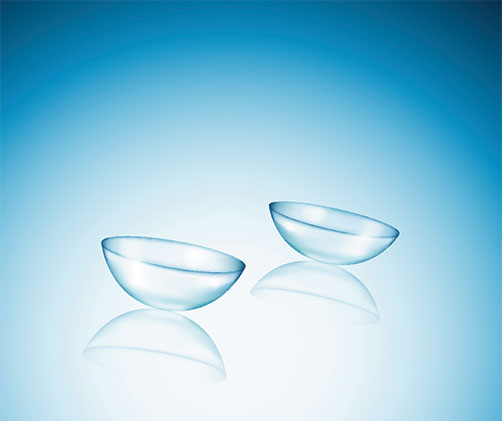Two clear, spherical contact lenses displayed against a blue background.