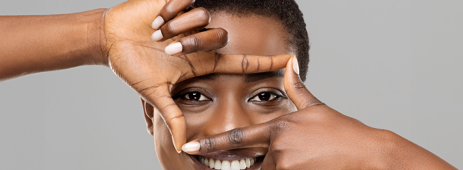 Person holding smartphone displaying dental implant simulation.