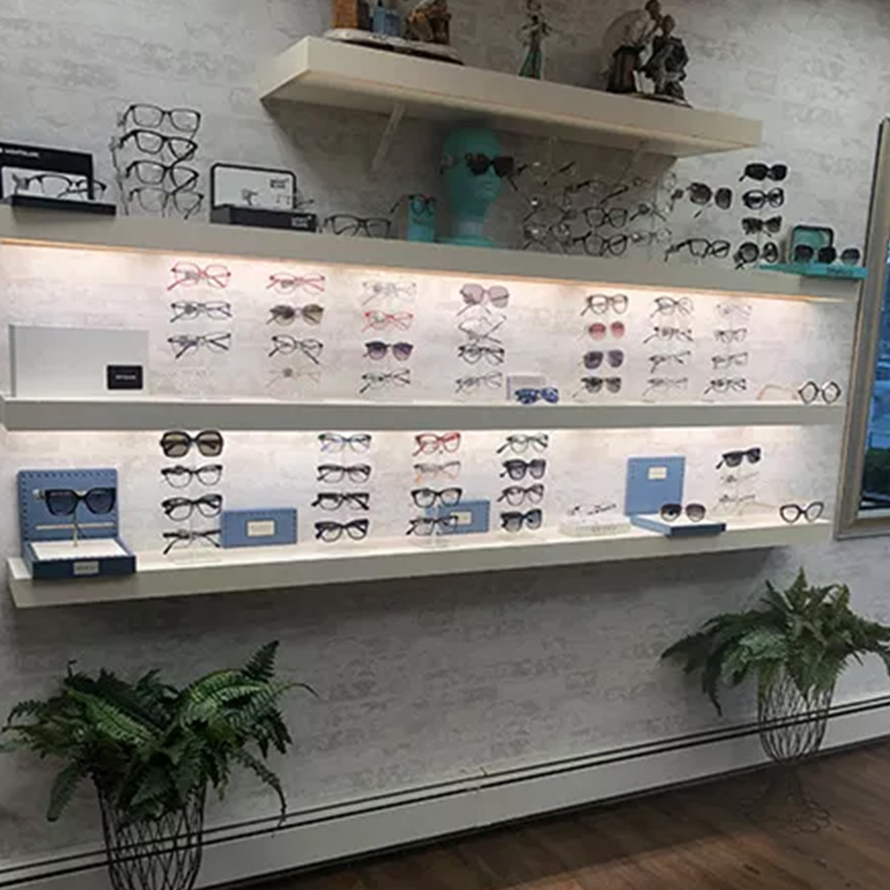An optical store display with various eyeglass frames and cases.
