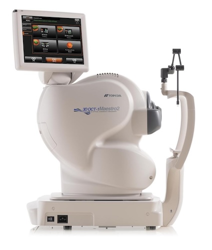 The image shows a large, advanced eye examination machine with a digital interface displaying various test results and options.