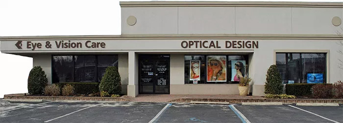 An exterior view of a small, single-story building with a sign that reads  EYE   VISION CARE  and a  MEDICAL EYE CARE  sign in the window.