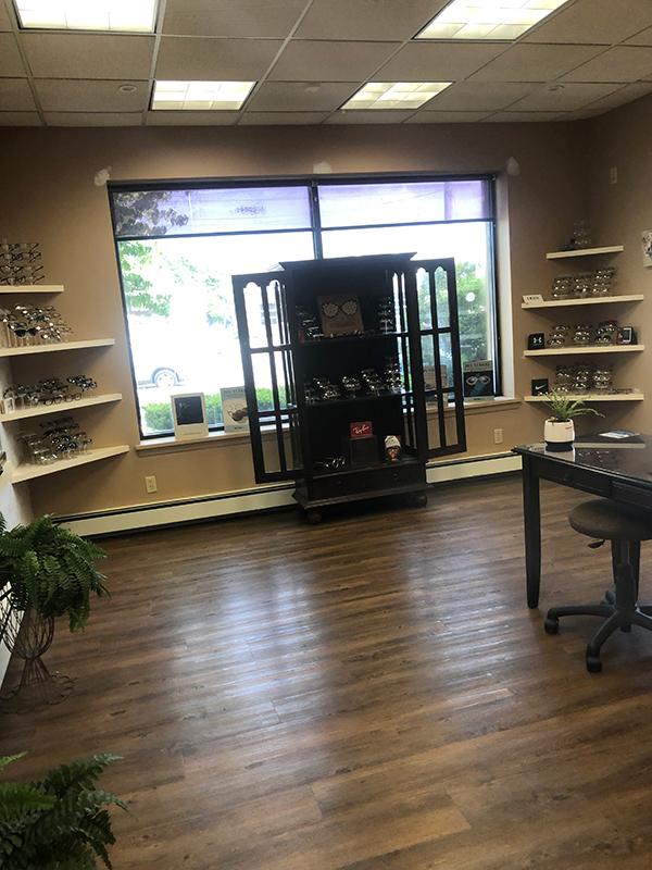 The image shows an interior space, likely a retail store or office, with a display of items on shelves and a clean, well-lit environment.